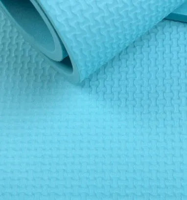 Red EVA fitness composite yoga mat with rolled edge showing 4mm thickness on a wooden floor.