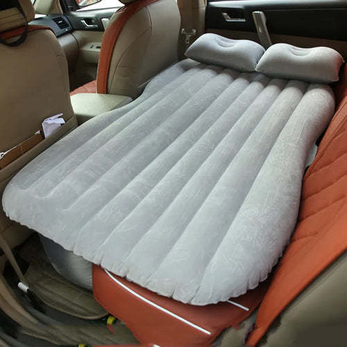 Universal inflatable car bed with flocking material, shown with pump, pillows, and storage bag.