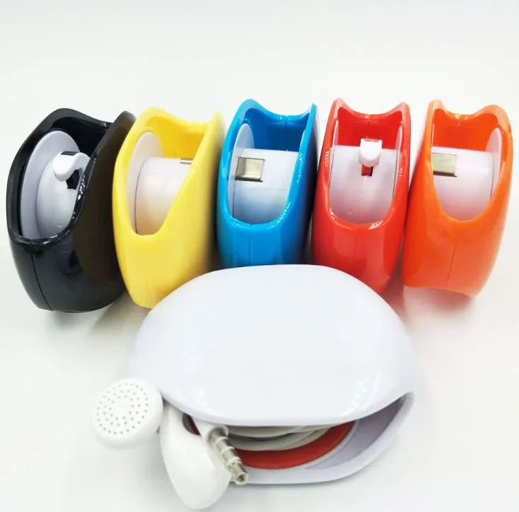 Automatic earphone cable winder retractor in blue, showing compact size next to a 3.5mm jack.