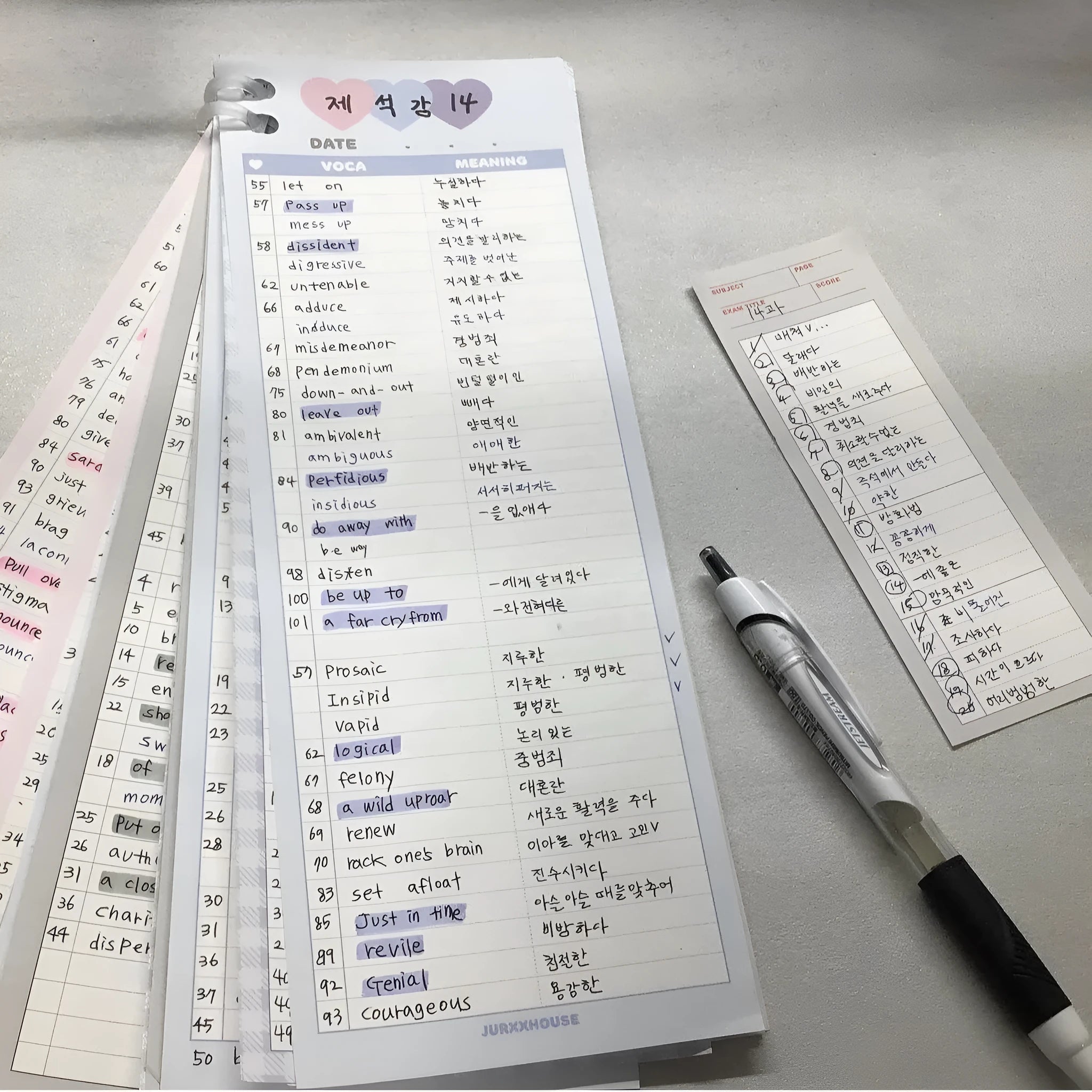 Half-B5 size vertical notepad with coloured cover, shown open to show lined pages.