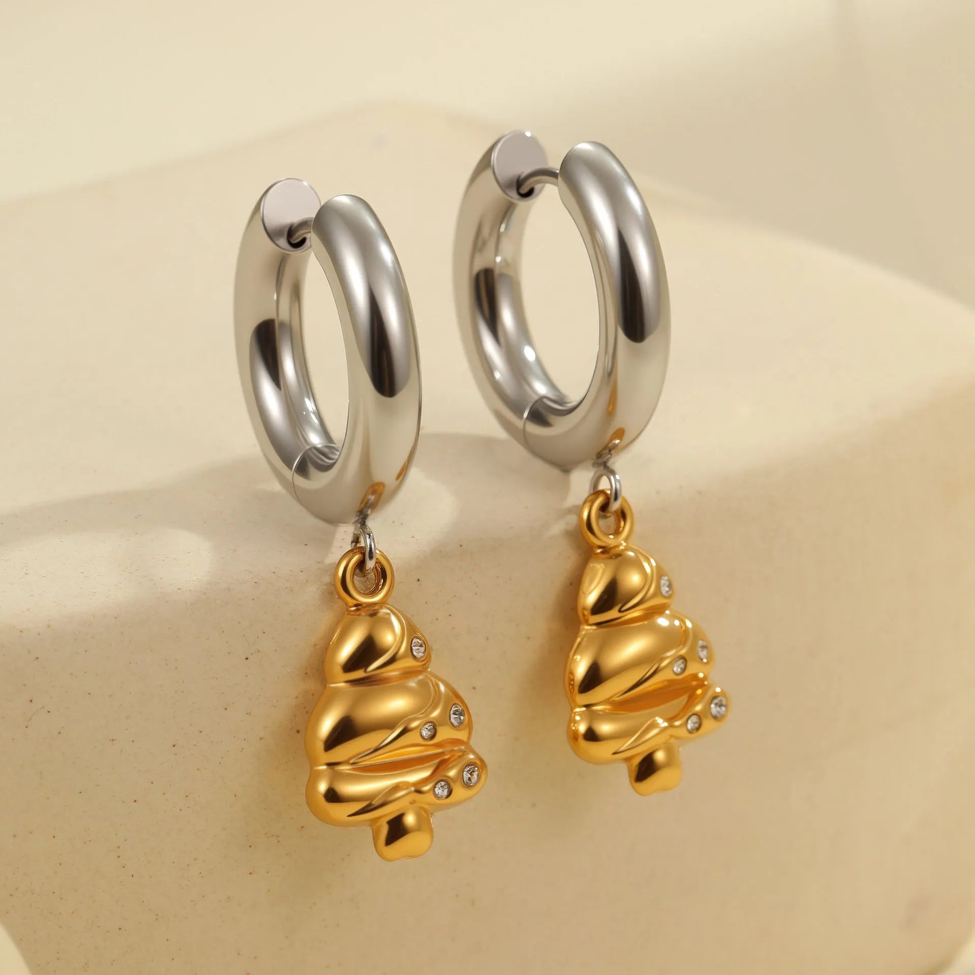 Stainless steel geometric earrings with 18K electroplated finish showing heart and star shapes