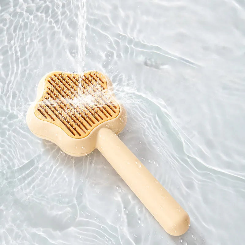 Green self-cleaning cat grooming comb with stainless steel needles and wand handle