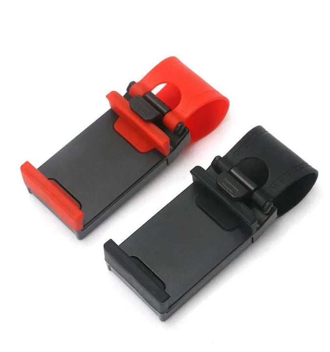 Black universal steering wheel phone holder clip mounted on a car steering wheel, holding a smartphone.