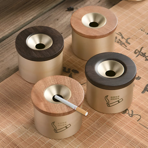 Retro brass ashtray with wooden lid showing centre hole design for ash collection