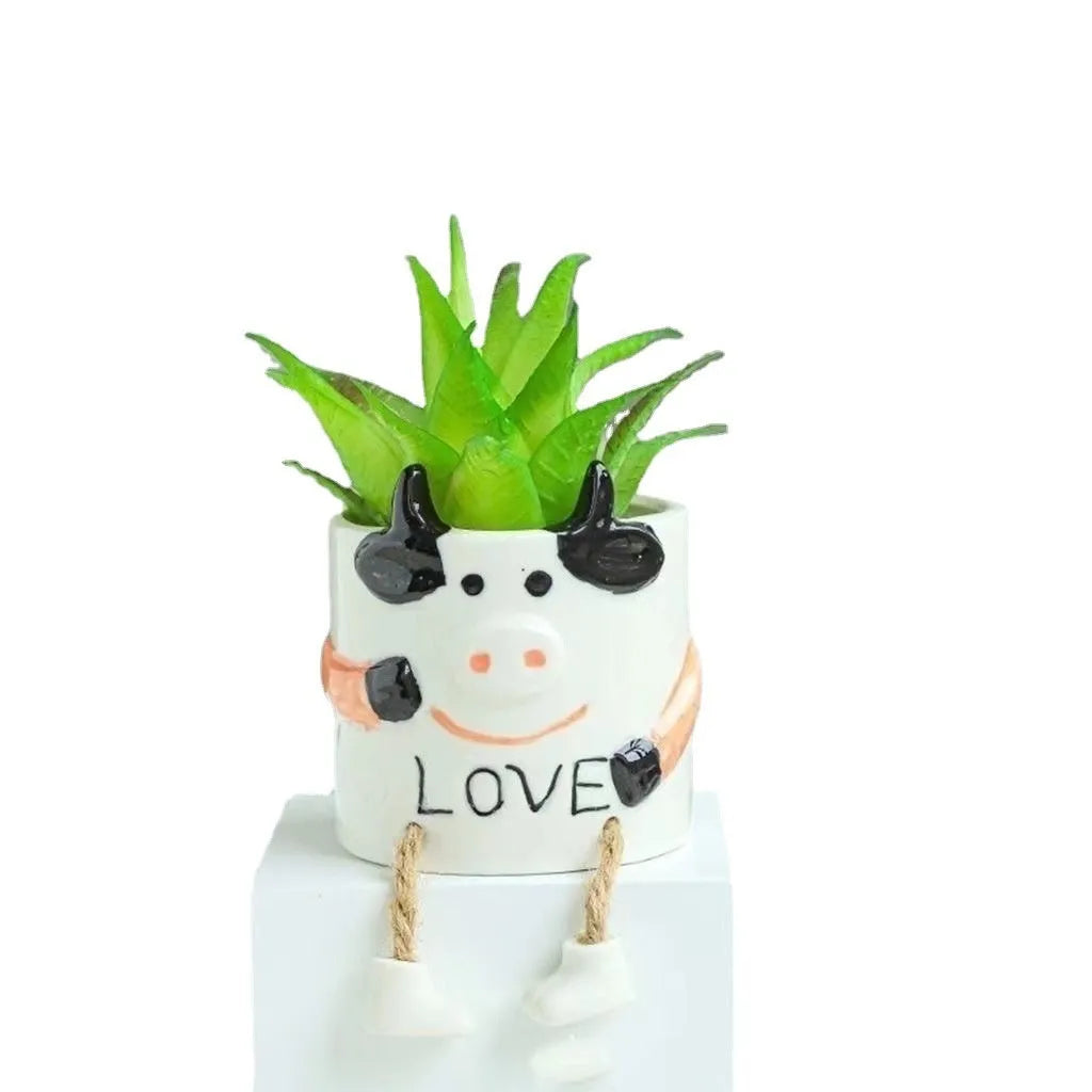 Cartoon-style ceramic hanging foot flower pot for succulent plants on a desktop.