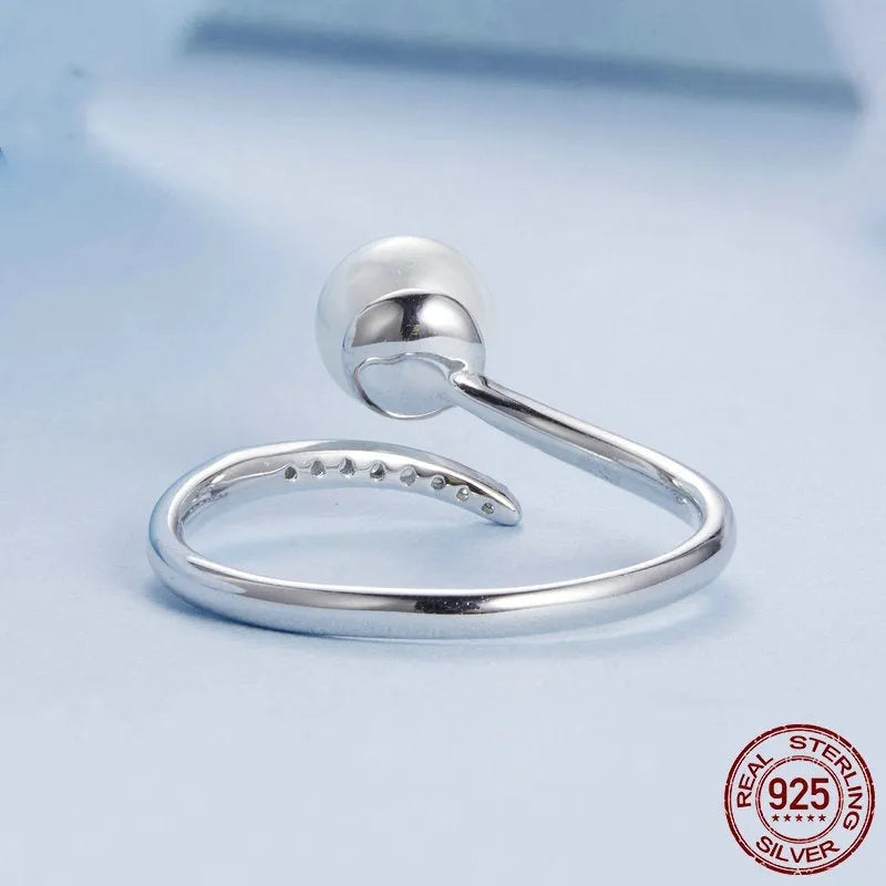 Sterling silver adjustable ring with shell pearl centrepiece on grey background