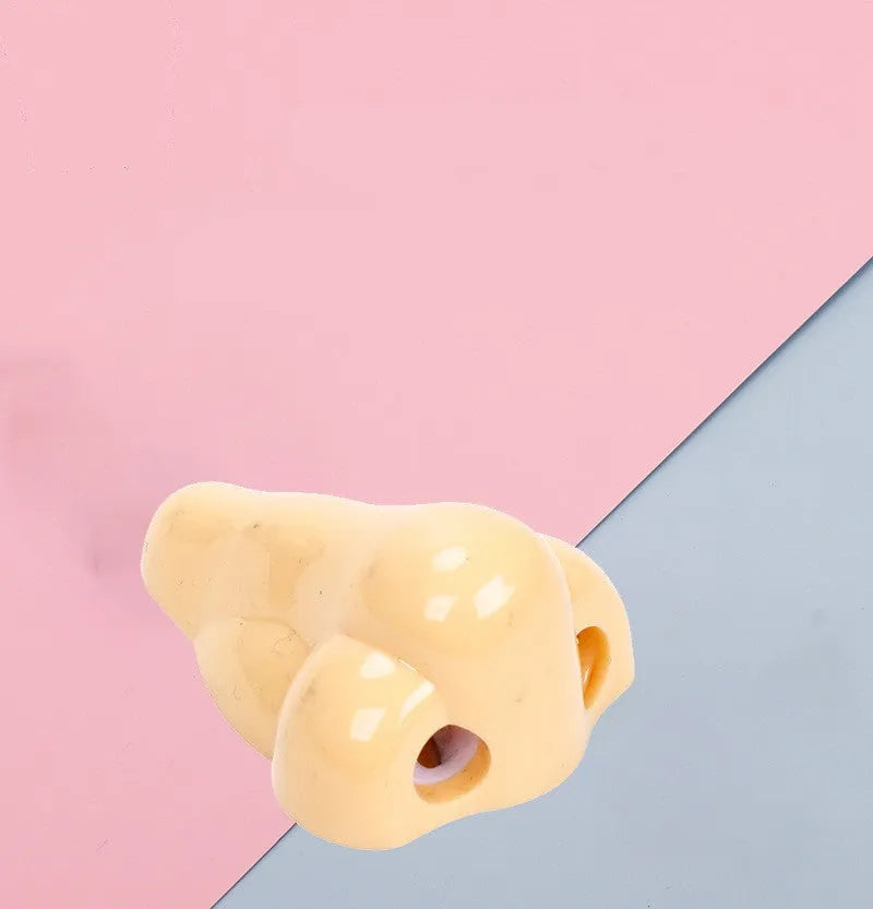 Flesh colour plastic geometry-shaped pencil sharpener with large sharpening holes.