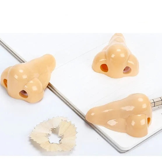 Flesh colour plastic geometry-shaped pencil sharpener with large sharpening holes.