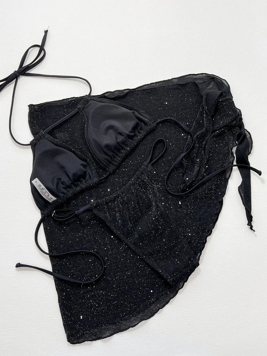 Black three-piece bikini swimsuit set with top and shorts on a mannequin