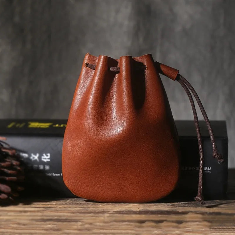 Vintage cowhide leather drawstring pouch wallet in black shown open and closed