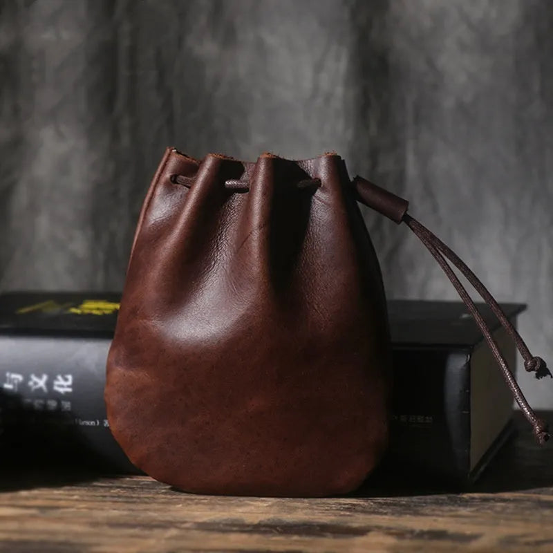 Vintage cowhide leather drawstring pouch wallet in black shown open and closed