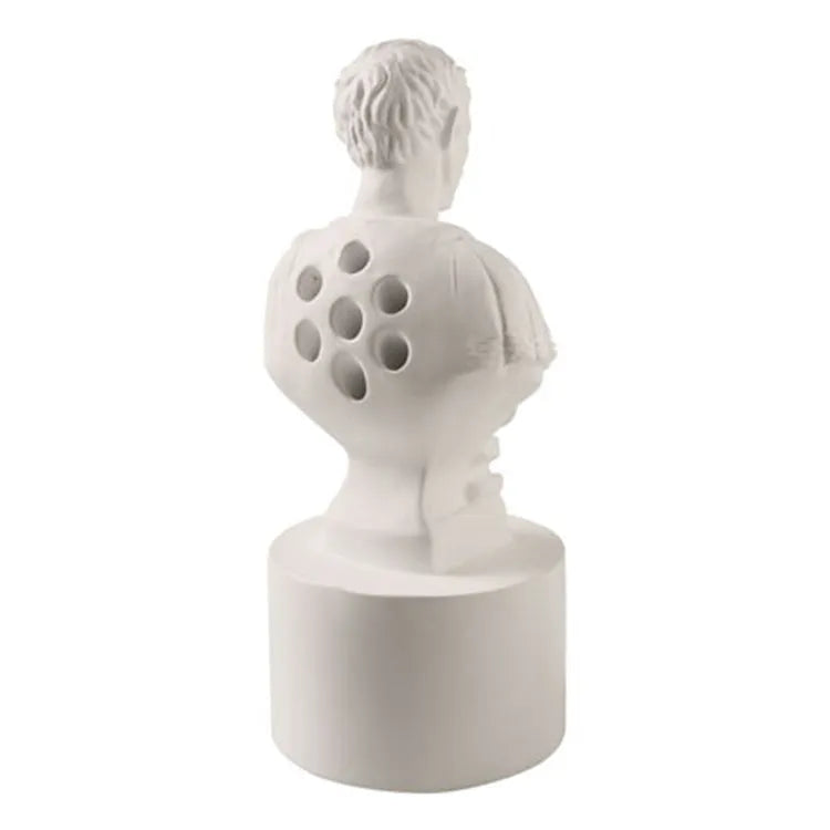 White synthetic resin pen holder with American creative character modelling on a desk.
