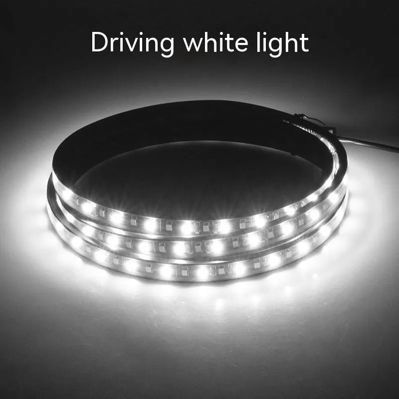 Pair of yellow pedal streamer side light lamps in flexible PVC casing on a dark background