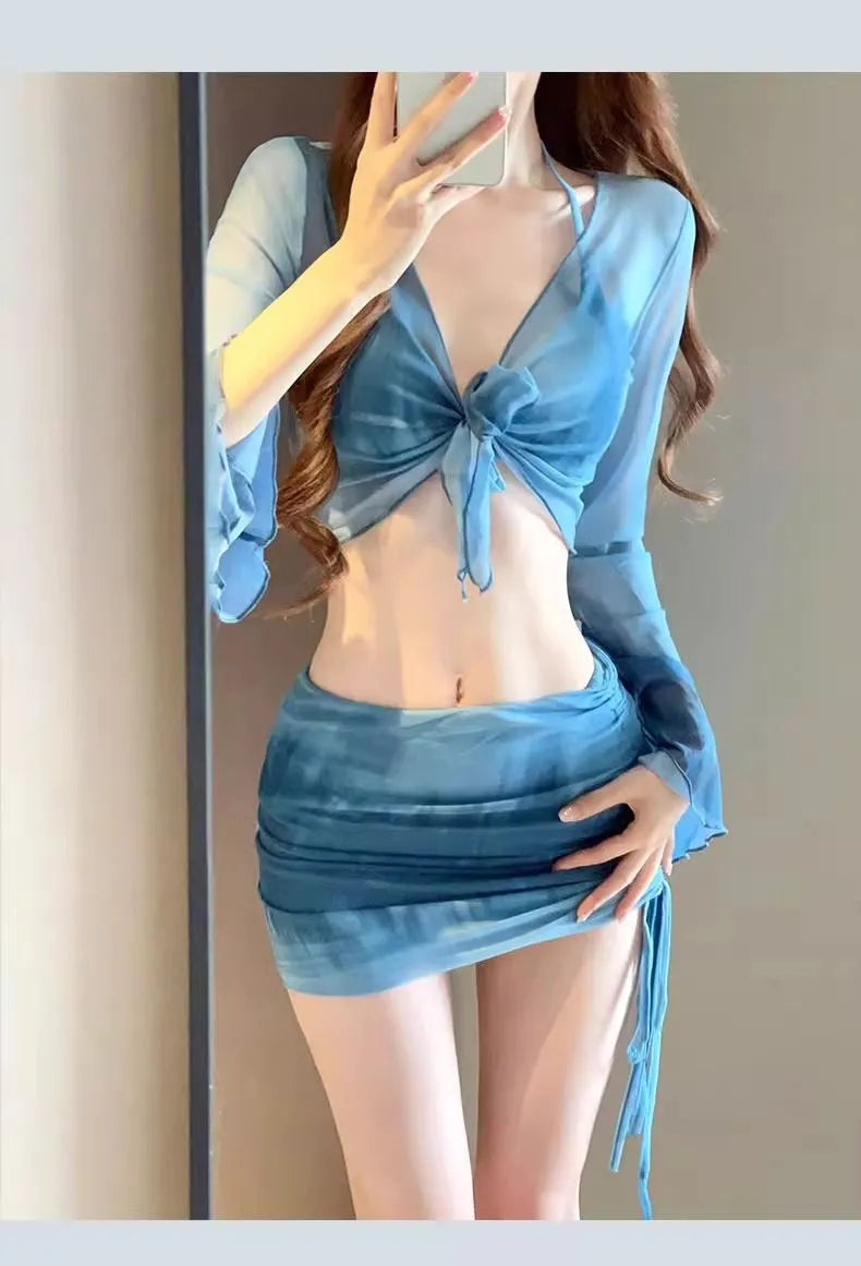 Blue women's high-waist bikini four-piece set showing shirt, bra, briefs, and skirt laid flat.