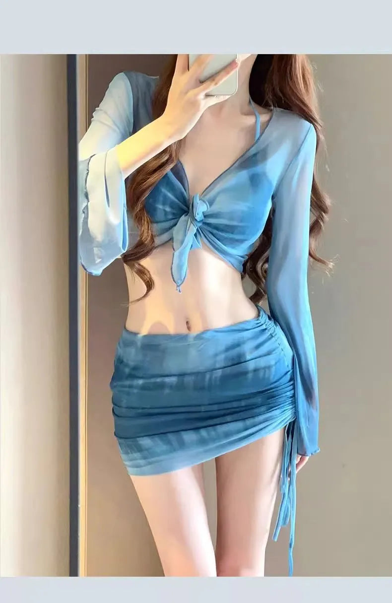 Blue women's high-waist bikini four-piece set showing shirt, bra, briefs, and skirt laid flat.