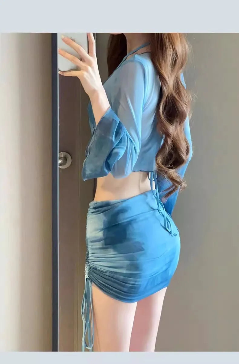 Blue women's high-waist bikini four-piece set showing shirt, bra, briefs, and skirt laid flat.