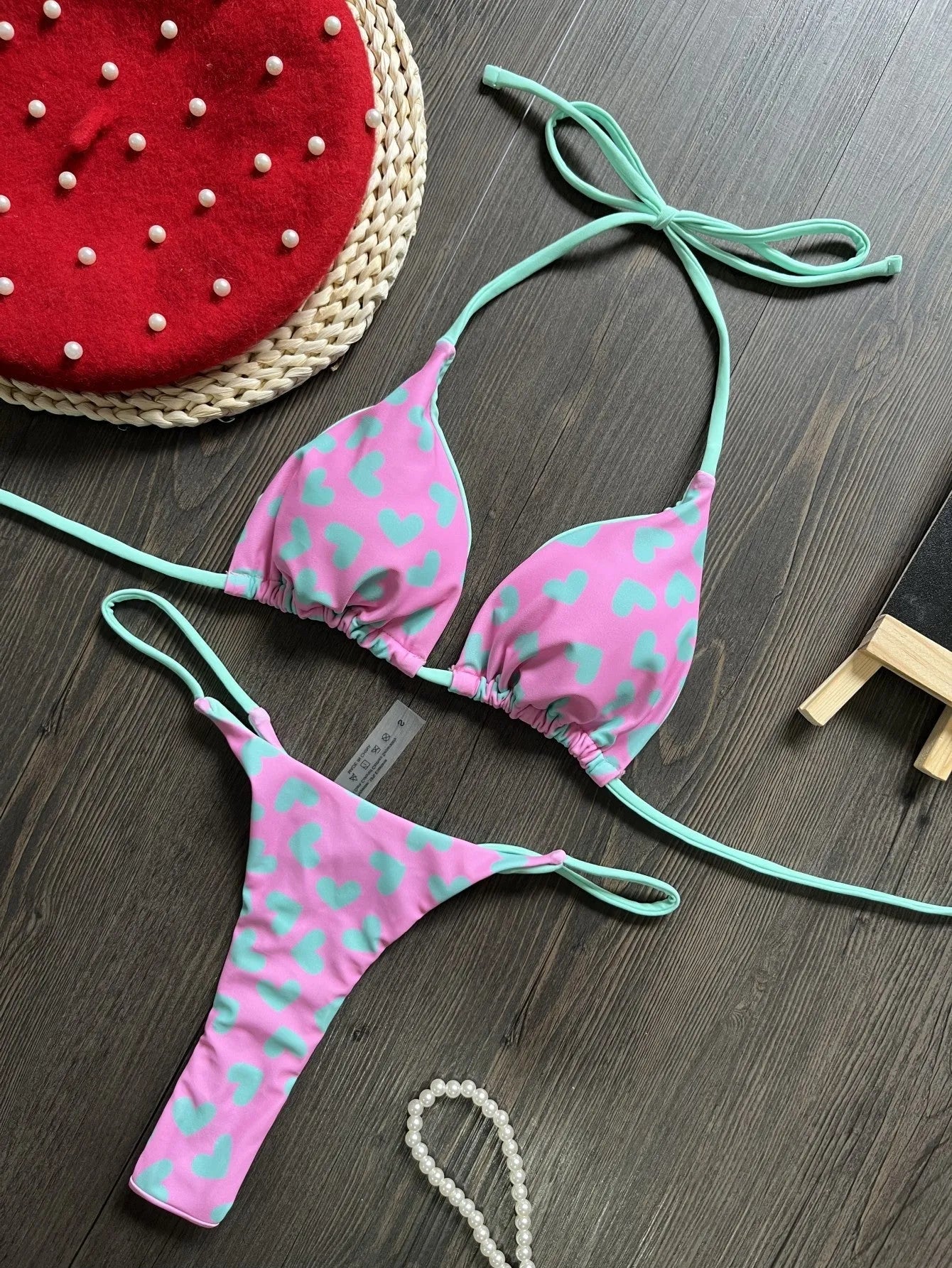 Women's heart print backless swimsuit in briefs style with cotton lining.