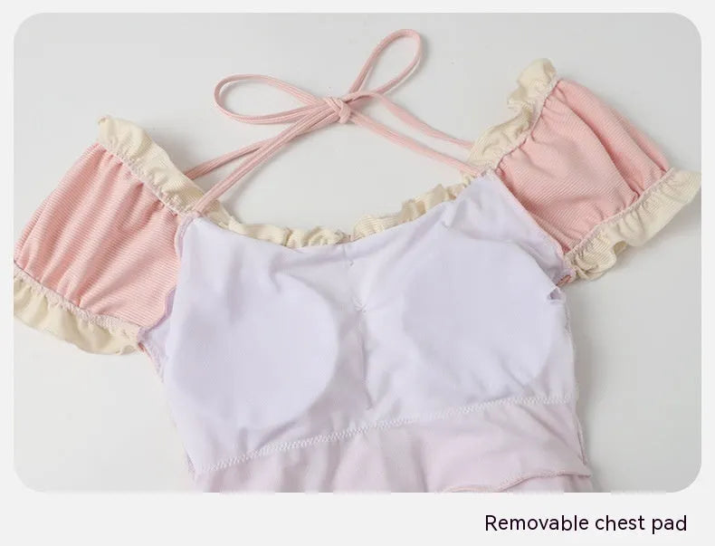 Pink women's one-piece swimsuit made from nylon fabric in conservative design