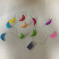 Handwoven rattan moon pendant fairy light chain with warm white glow on a dark background