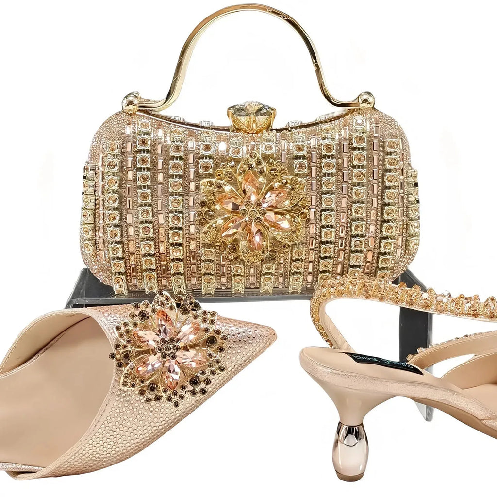 Women's black high heel shoe with floral rhinestone detail and matching hard clutch bag.