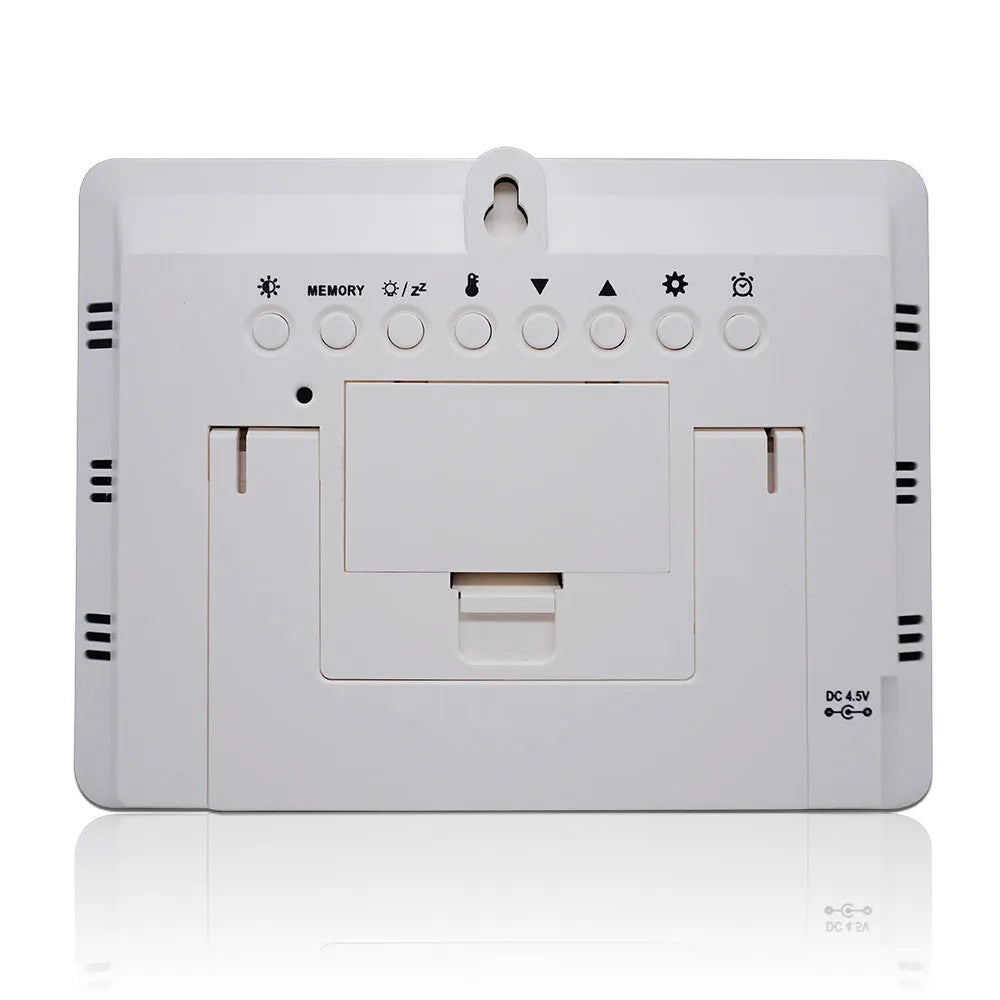 Rectangular black weather clock station with LCD display showing time, temperature, and humidity readings