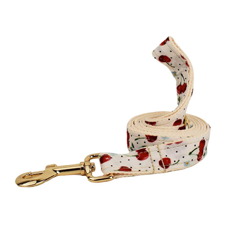 Red cherry printed dog collar and leash set with light gold buckle and bow on cloth material