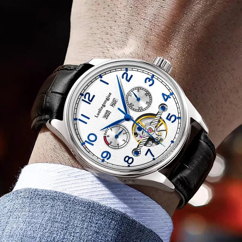 Men's stainless steel mechanical watch with a leather strap and sapphire crystal glass on a wrist.