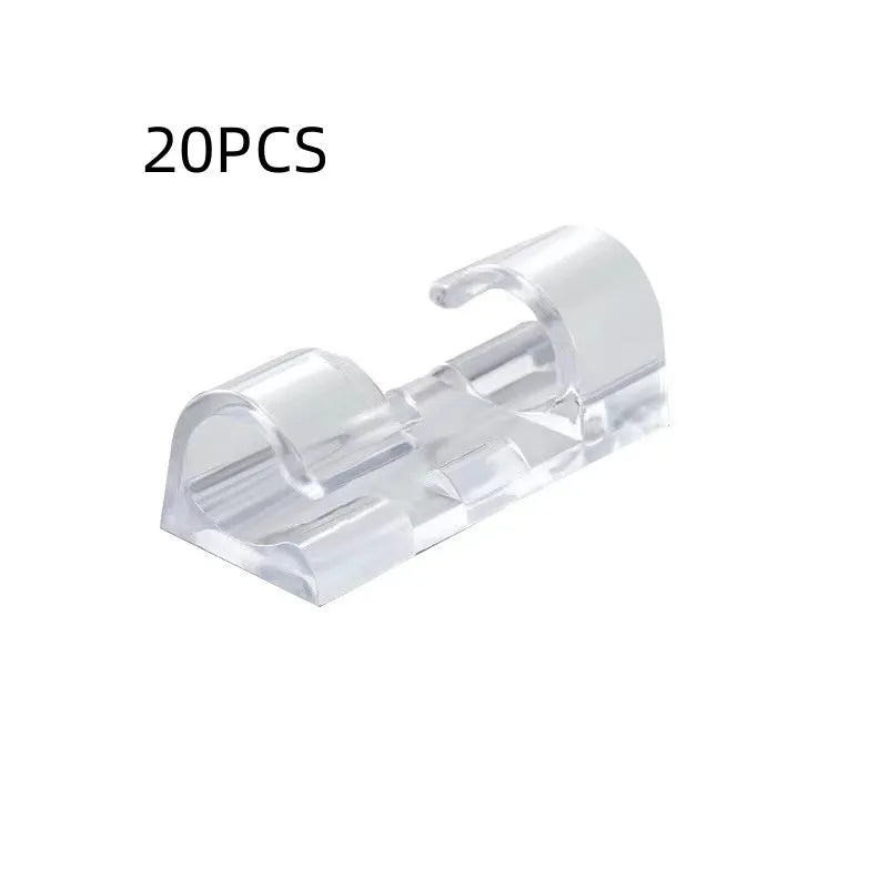 Transparent plastic self-adhesive cable management clips on a white background.