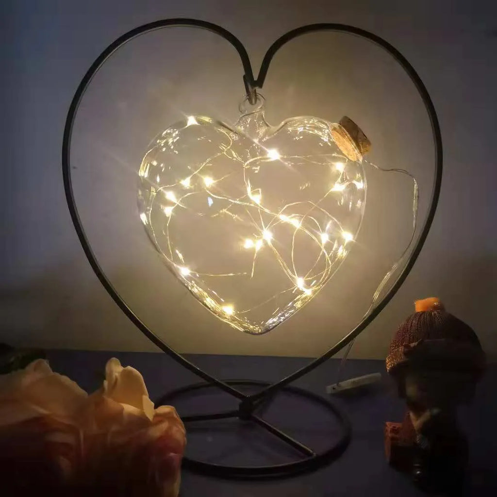 Round glass LED wishing bottle 12 cm with cork, 20 warm white lights, and folded star paper strips on a table