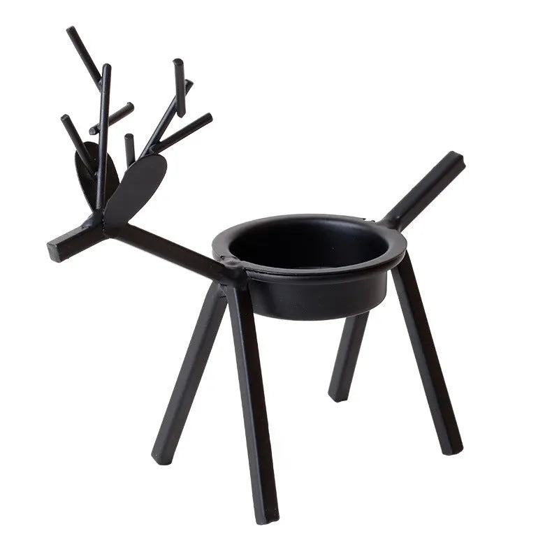Black iron Christmas candlestick holder with decorative elk bracket design.