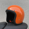 Retro-style motorcycle half helmet in cement grey with a glossy fibreglass shell on a plain background.