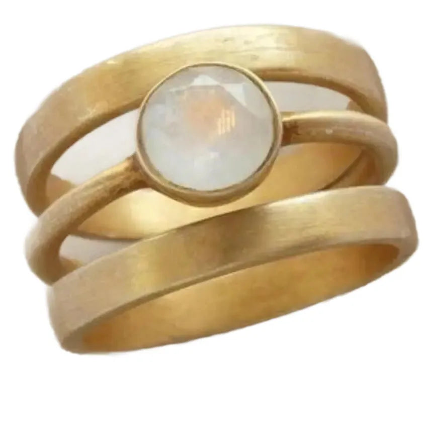 A gold-plated geometric ring with a hollow micro-inlaid white chalcedony stone on a titanium steel band.