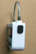 Electronic timer lock for bondage and chastity restraints, black or white ABS and steel wire, USB rechargeable, with screen and buttons.