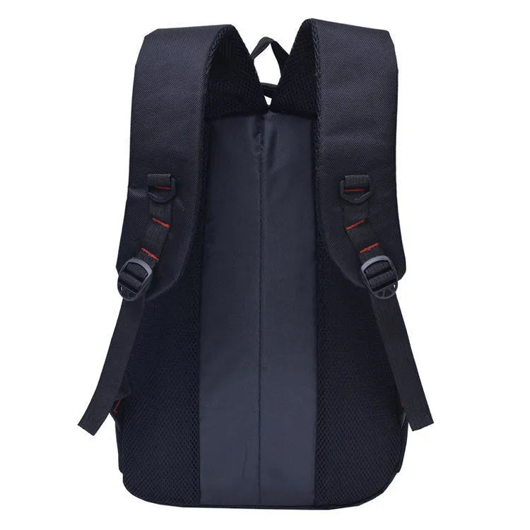 Black casual nylon travel backpack with padded laptop sleeve and front pockets on a table
