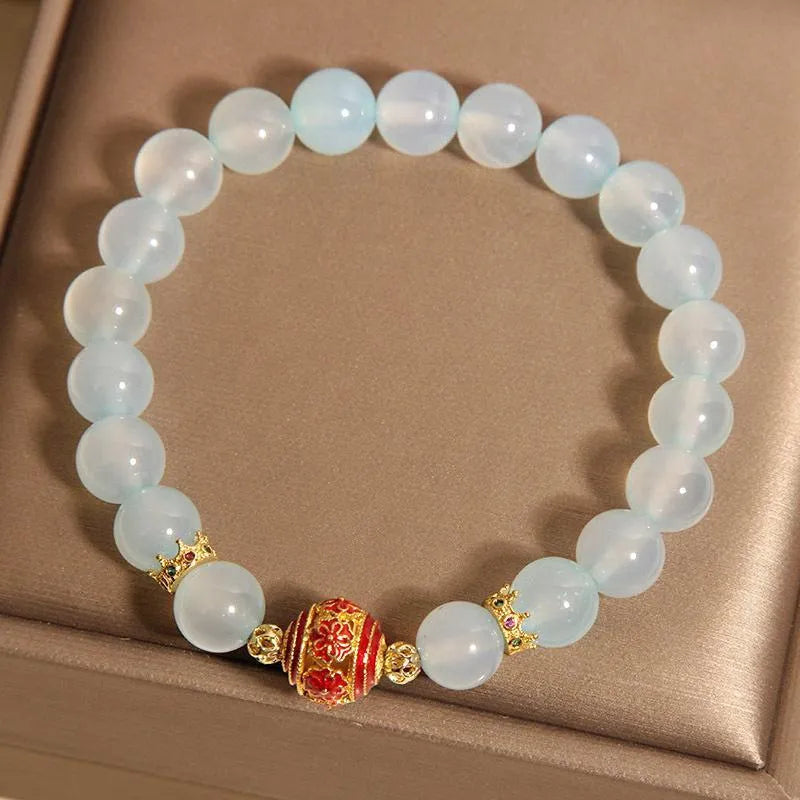 Women's blue agate and crystal bracelet with colourful lucky beads on a wrist.
