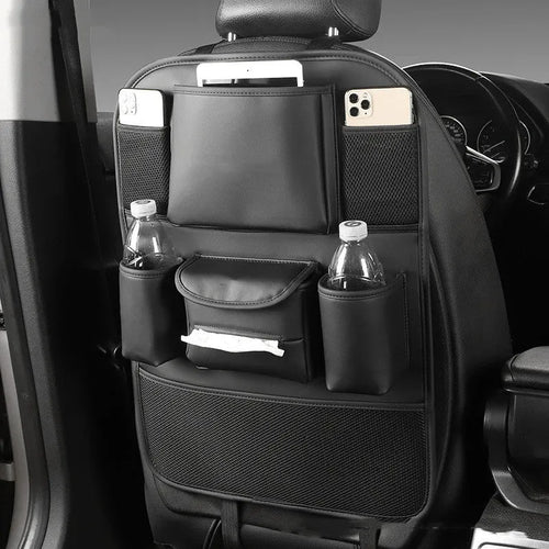 Leather car seat back storage bag in black, hanging behind a car headrest.