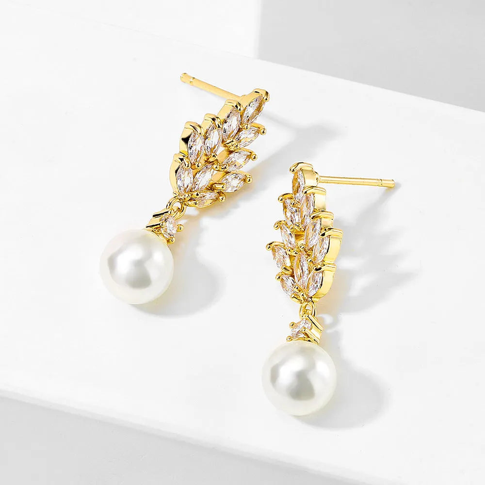 Gold plated geometric earrings with micro inlaid zircon stones in a floral design.