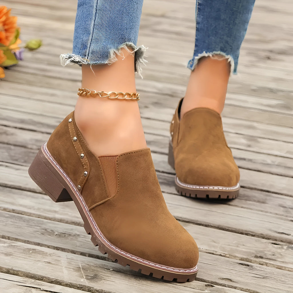 Women's light brown suede ankle boots with a low thick heel and elasticated ankle band.