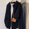 Beige viscose soft sweater coat cardigan with long sleeves on a hanger