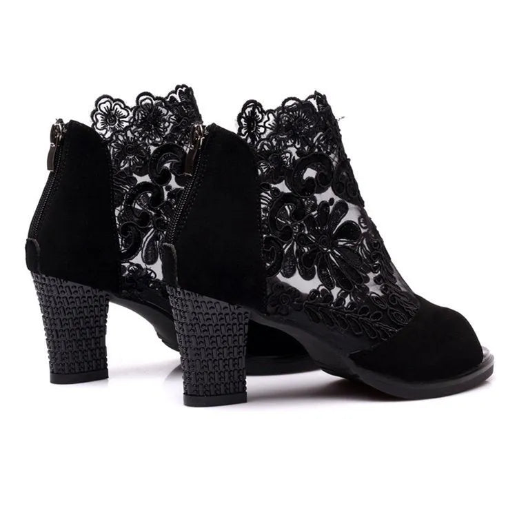 Women's black lace gladiator sandals with square heels and floral patterns, showing zip closure and peep toe design