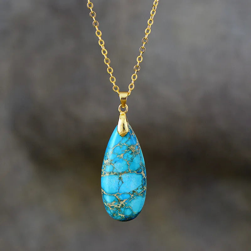 Emperor Stone water drop pendant necklace with genuine jade centre and 18K gold plated setting on a chain.