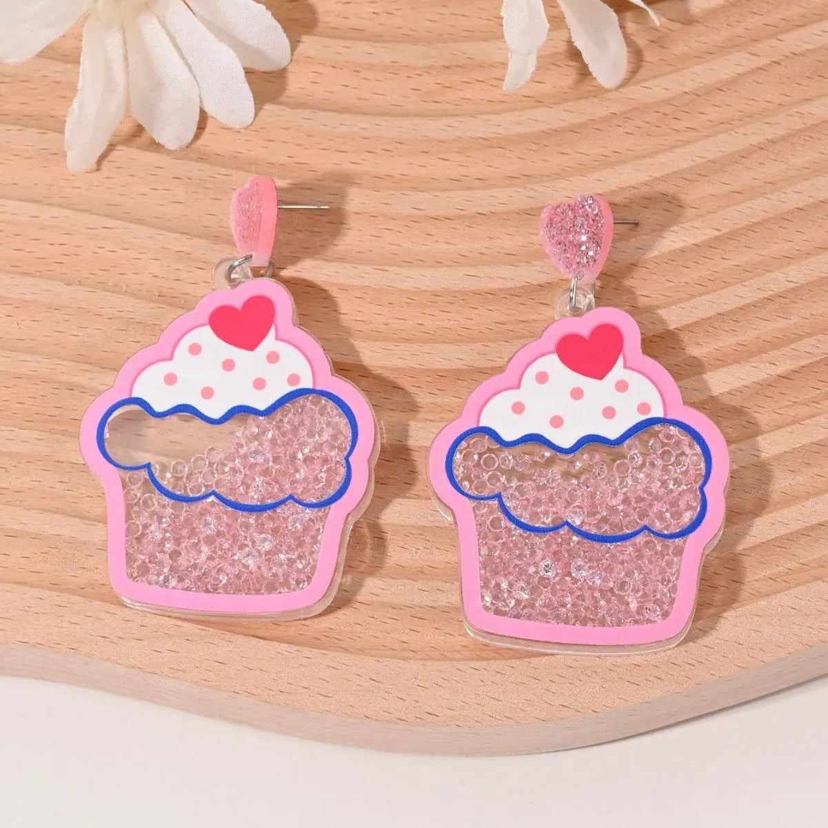 Colourful acrylic drop earrings with fruit and dessert charms including strawberry, cherry, pineapple, and watermelon.