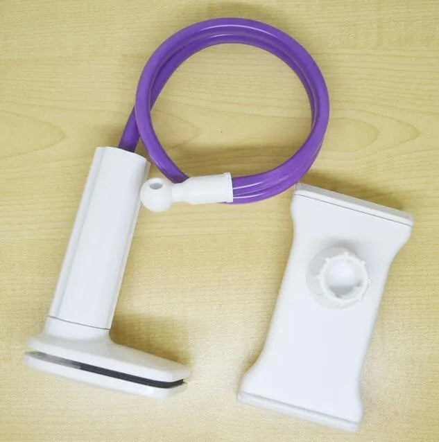 Black aluminium alloy bedside phone handset with a long arm and wide clamp, holding a mobile phone above a bed.