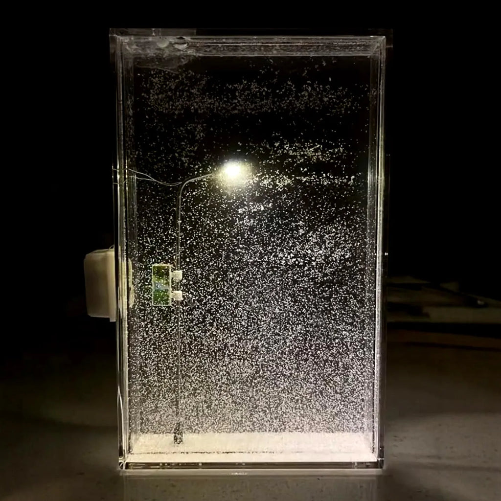 Assembled DIY snowy landscape night light with small street light and warm LED glow on a desktop.