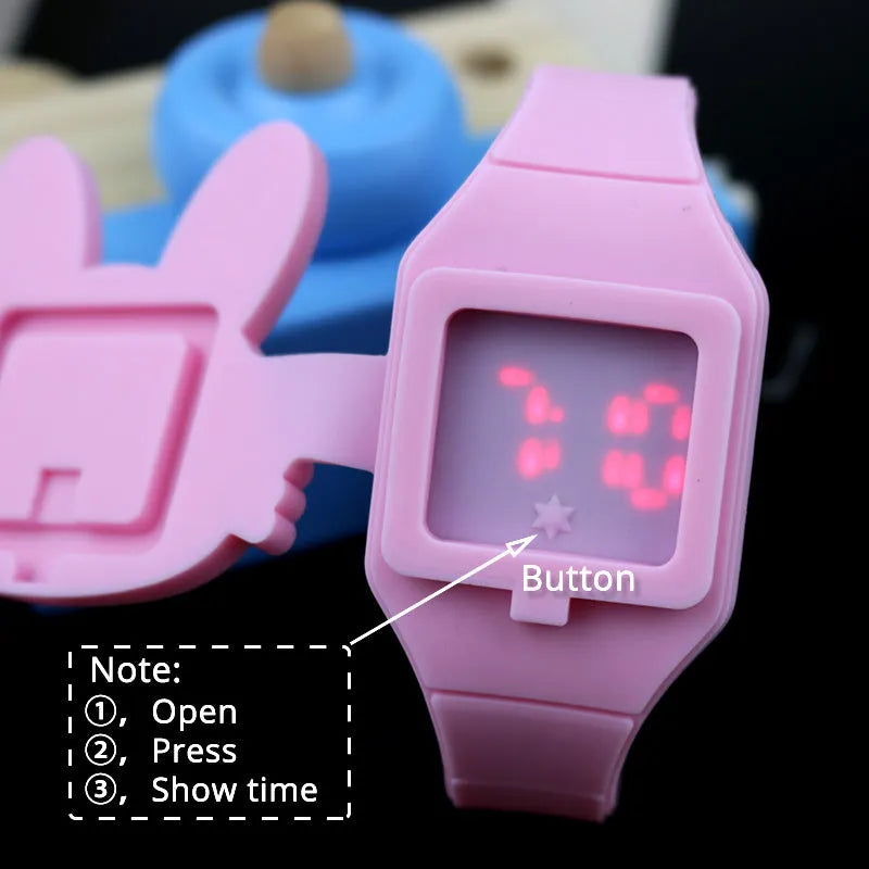 Children's electronic watch with 55mm plastic dial and silicone strap on a child's wrist