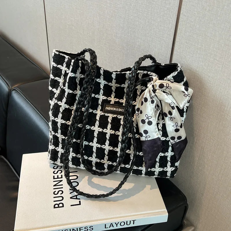 Black woolen horizontal square shoulder bag with weaving detail exterior and internal organisation compartments