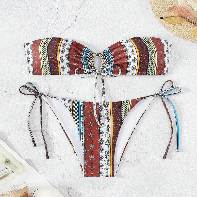 Women's printed lace-up split swimsuit in mixed colours, showing sleeveless one-piece design.