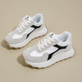 Women's solid colour platform sneakers with lace-up front and flat rubber sole.
