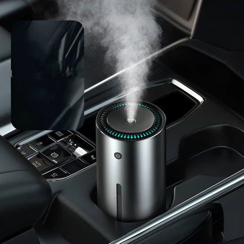 Black aluminium alloy car diffuser humidifier with USB cable on a desk.