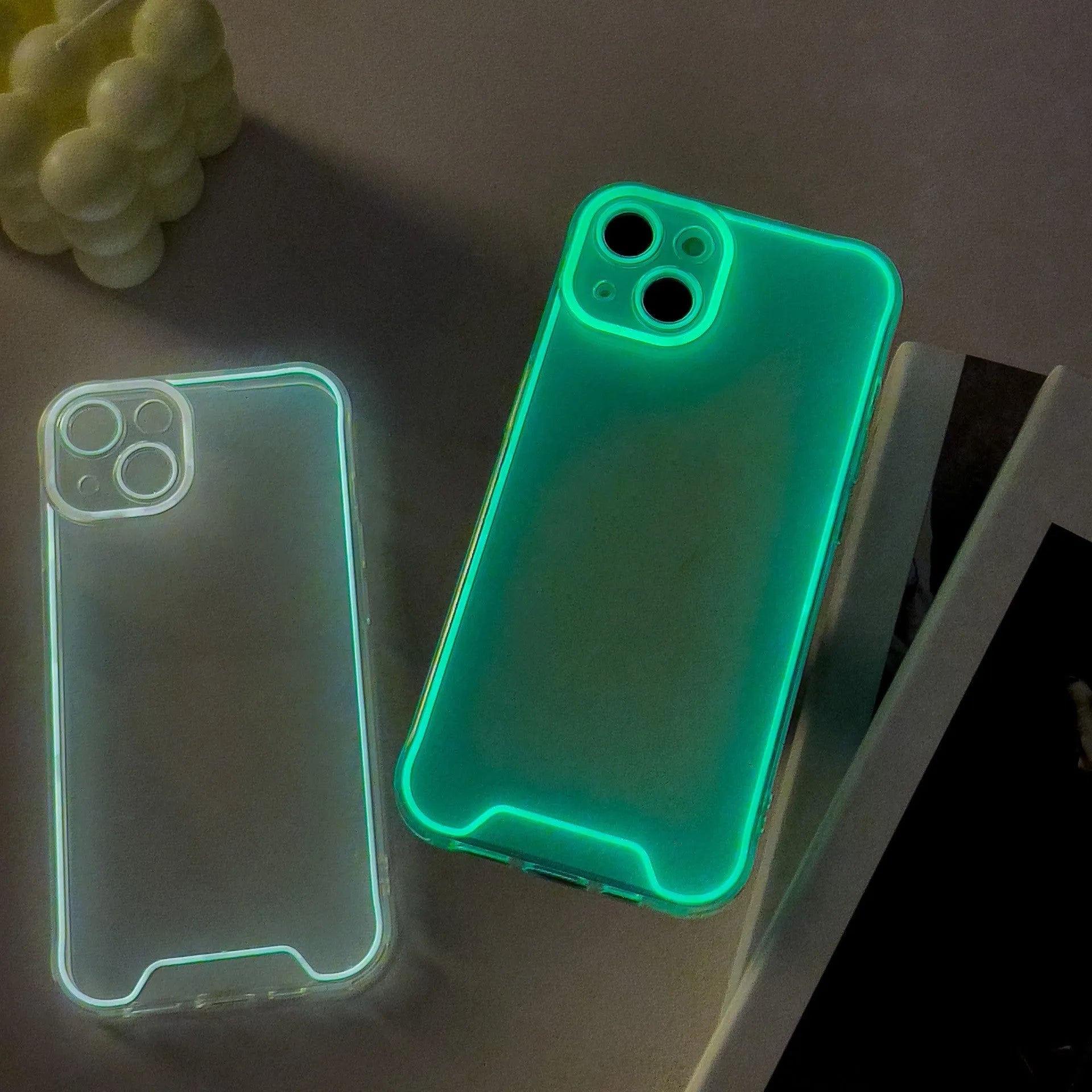Glow in the dark green Christmas phone case for iPhone on a dark background.